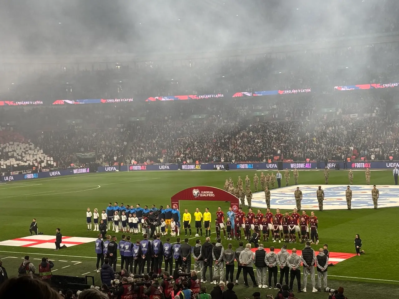 Teams lining up before an international match in a full stadium